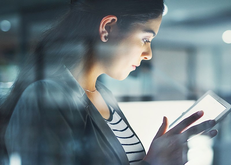 Woman in an office reading a tablet